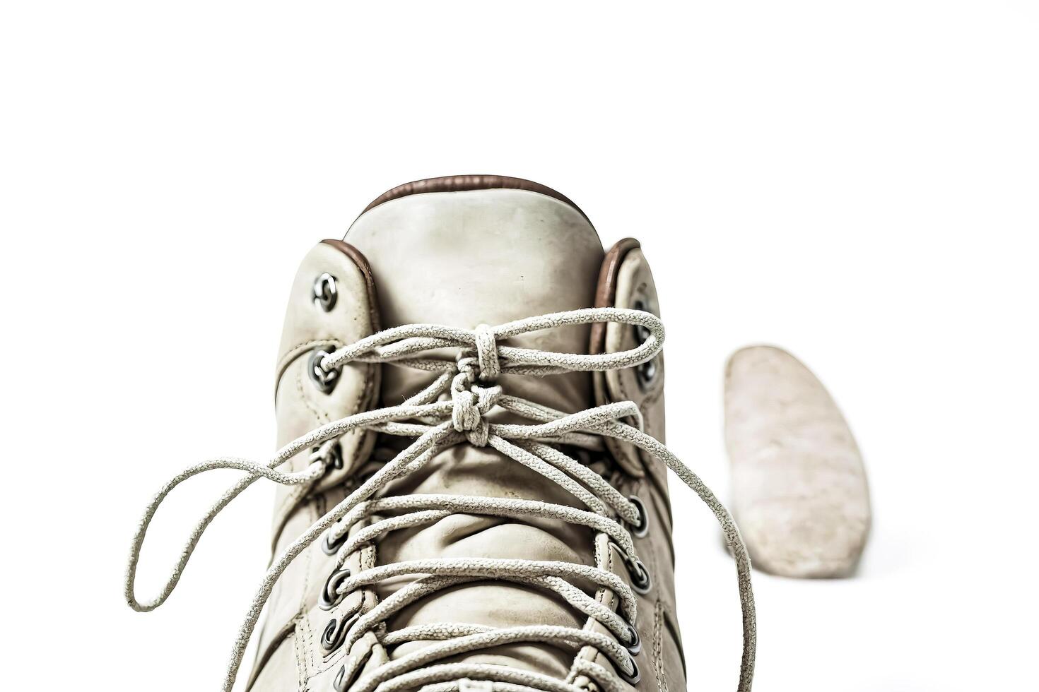 Close Up of White Boot Laces with Blurred Outsole photo