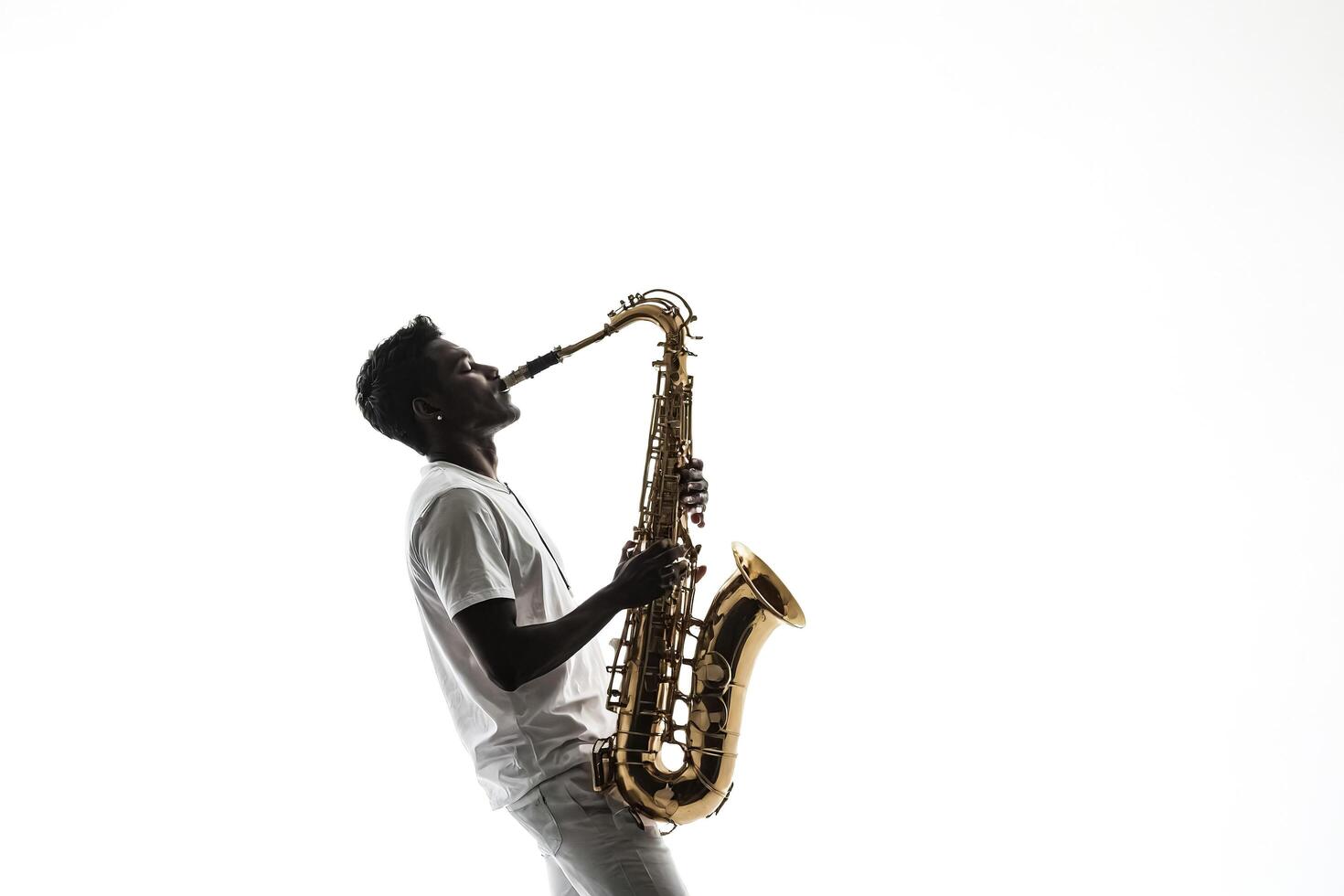 Silhouette of a Saxophonist Playing on White Background photo