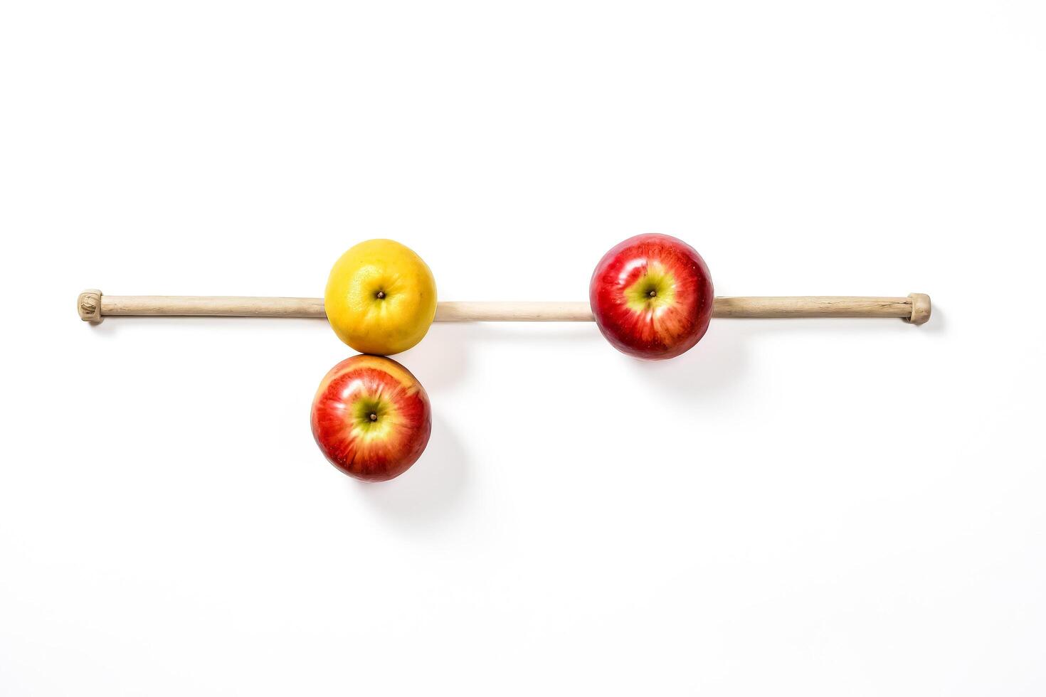 Yellow Apple and Red Apples on a Wooden Stick photo