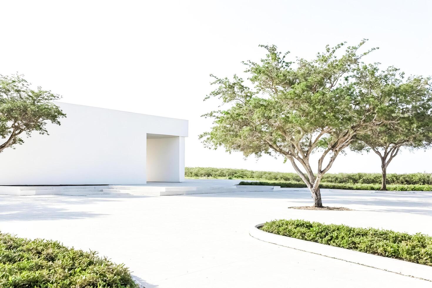 Minimalist White Building with Green Trees in a Landscape photo