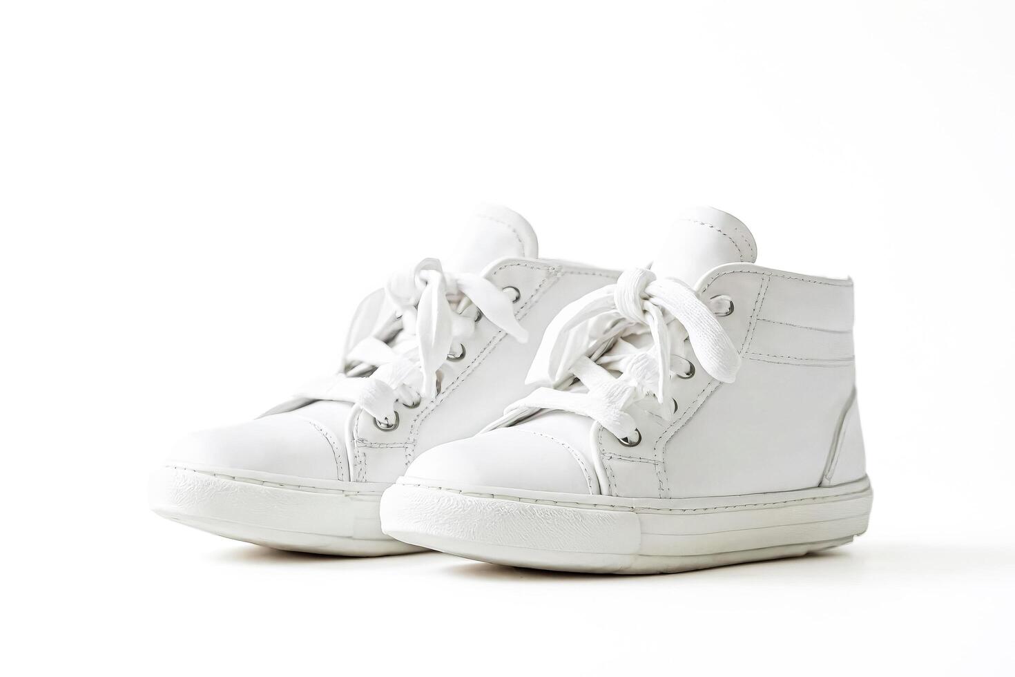 White leather sneakers on a white background photo