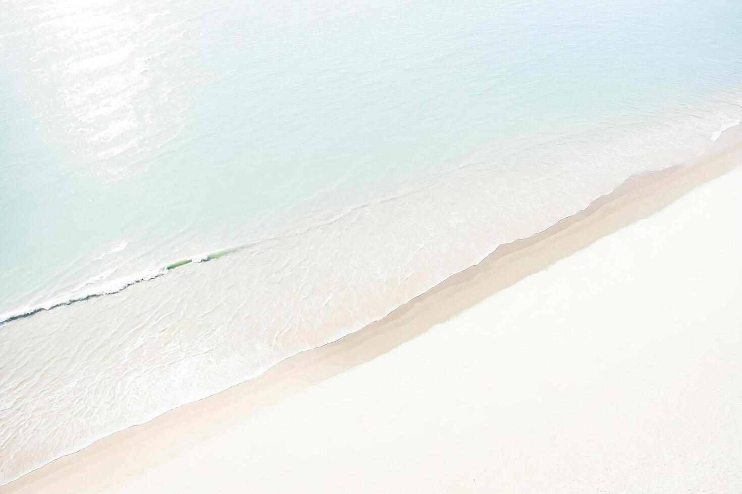 Aerial View of Ocean Waves Meeting Sandy Shore photo