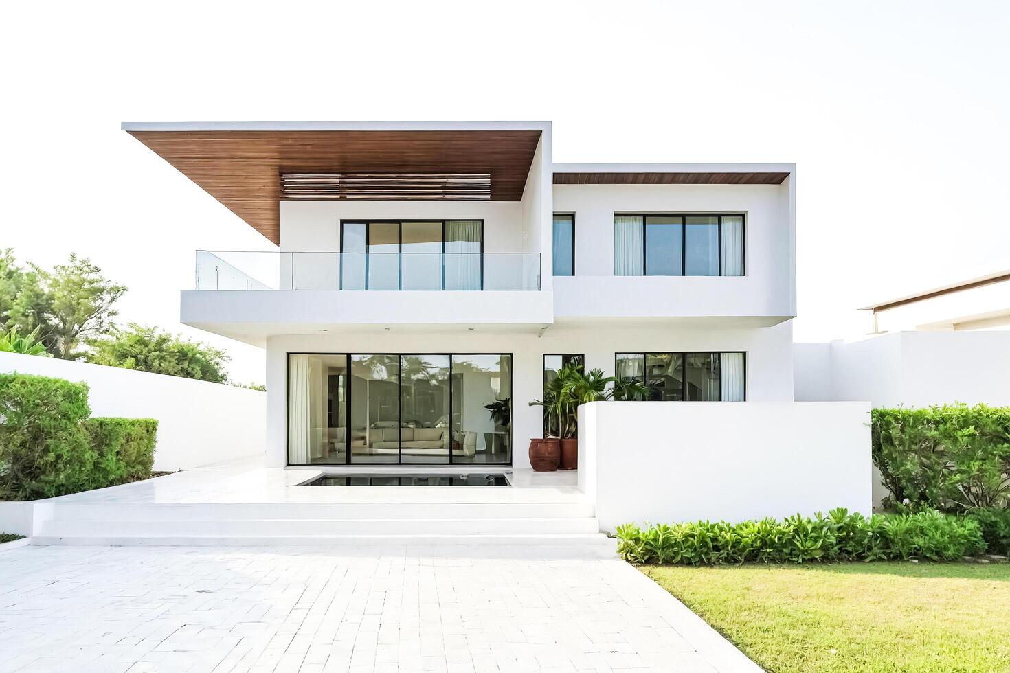 Modern White House with Pool and Lush Green Landscape photo