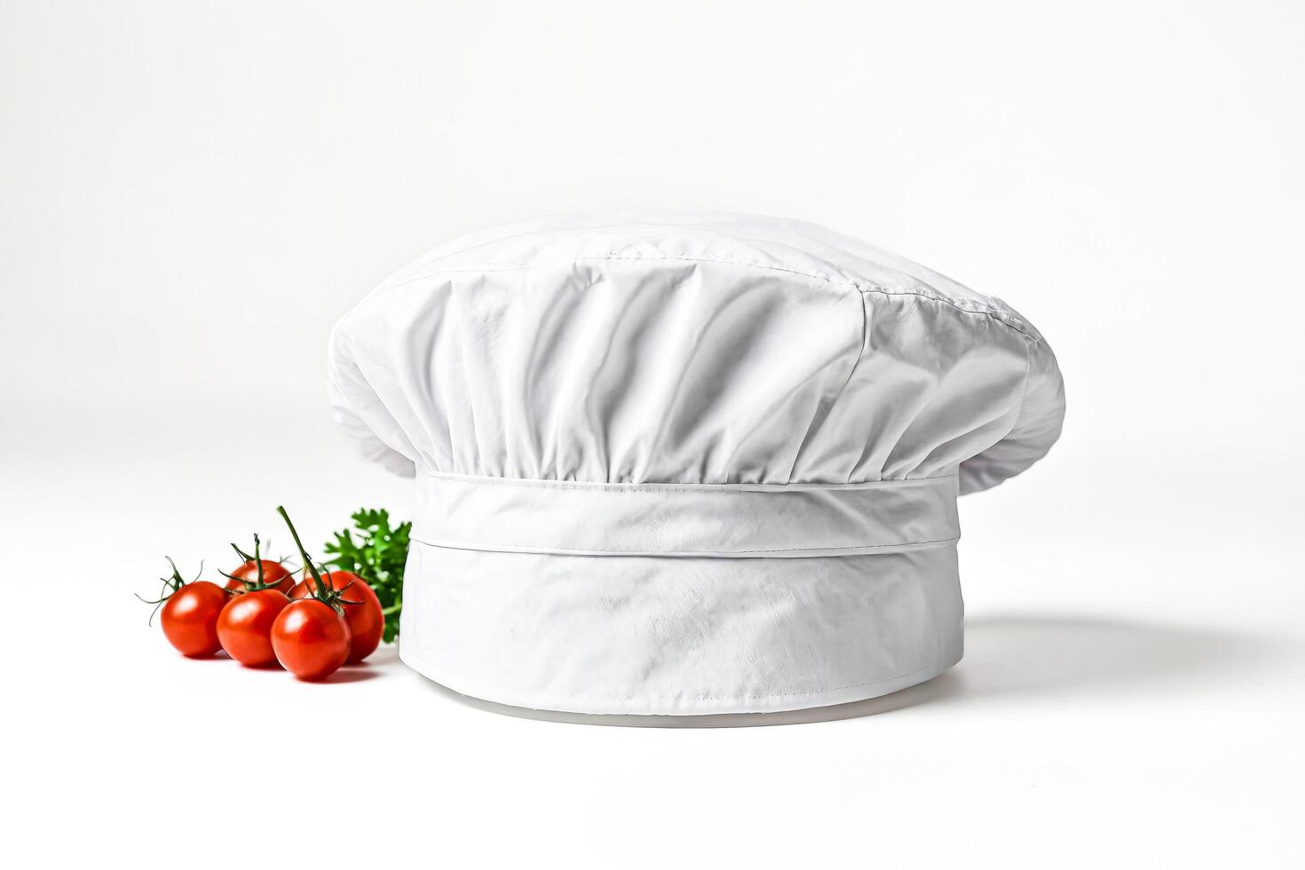 White Chef Hat and Tomatoes on White Background photo