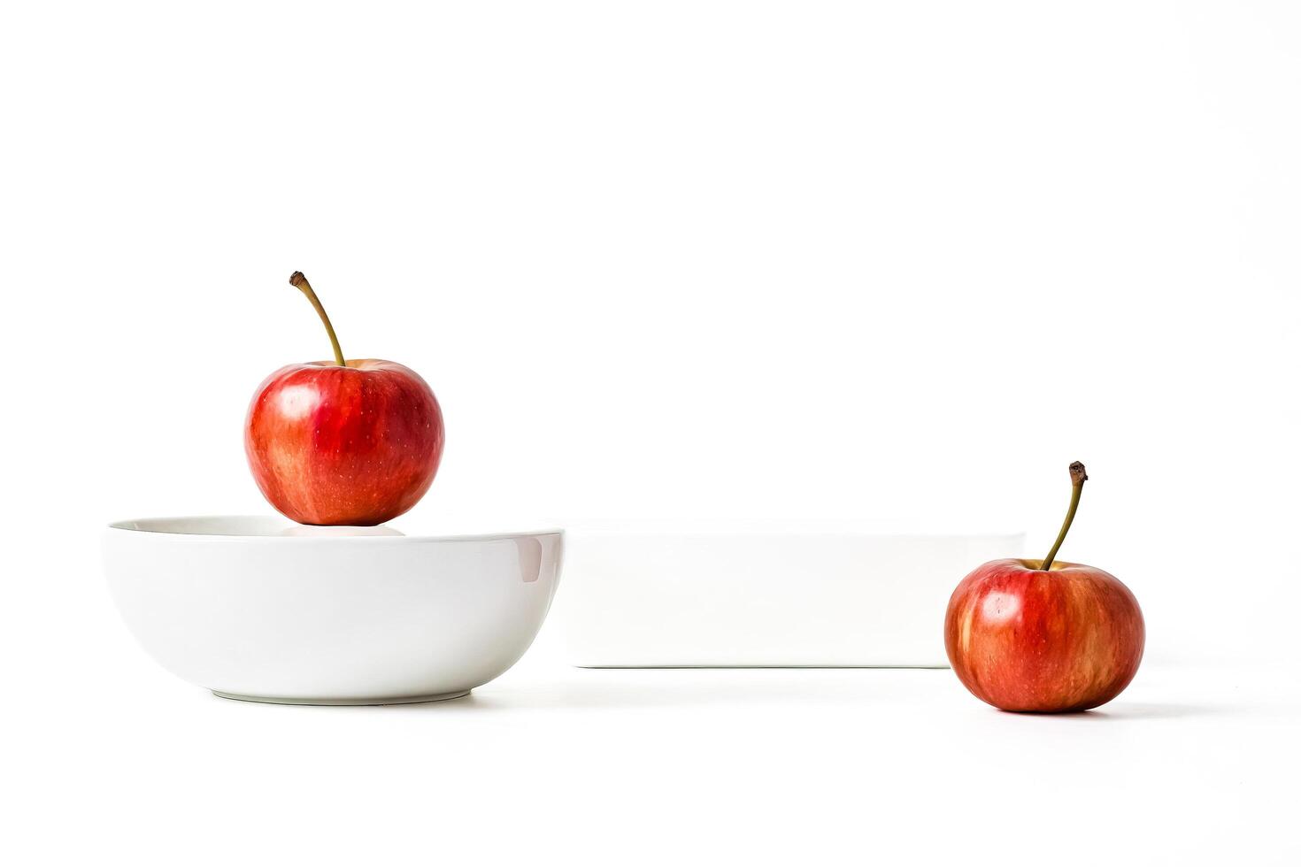 Red apple on a white bowl photo