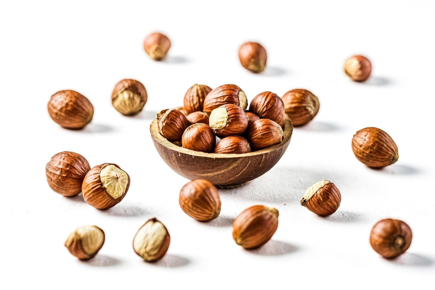 Hazelnuts in a wooden bowl on white background photo