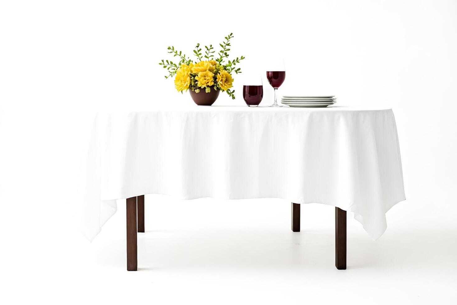 White Tablecloth on Round Table with Yellow Flowers, Wine Glasses, and Plates photo