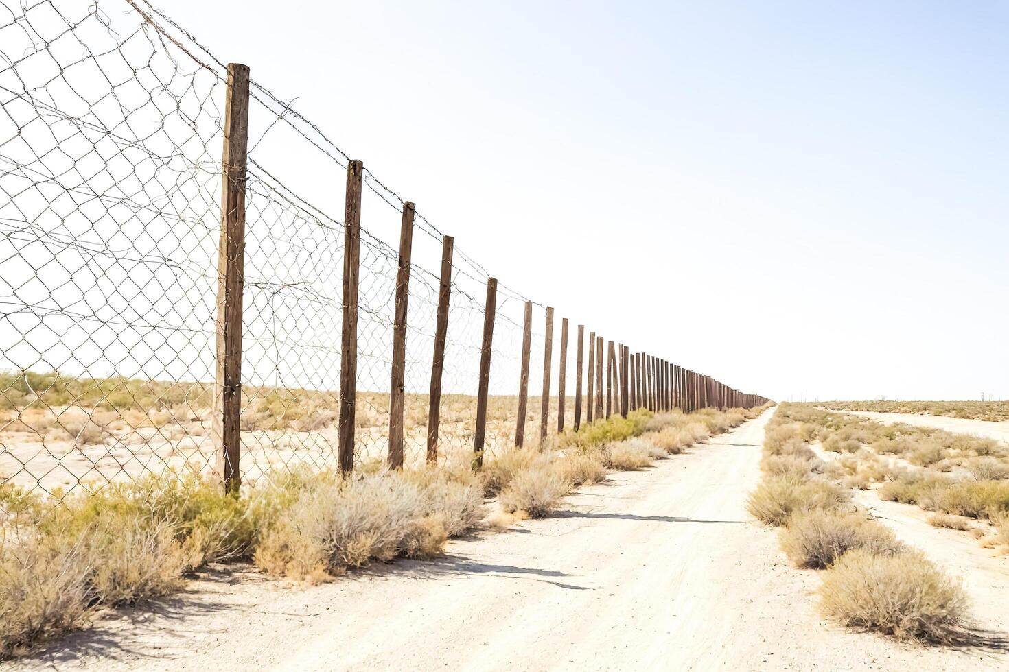 A long fence line in the desert photo