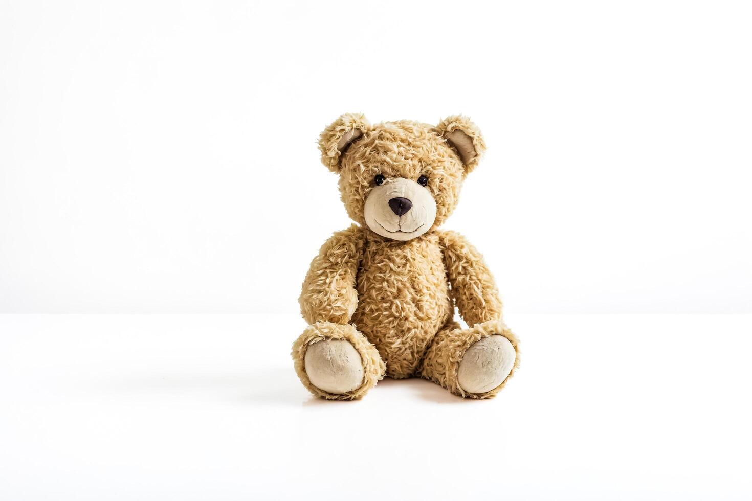 Brown Teddy Bear Sitting on White Background photo