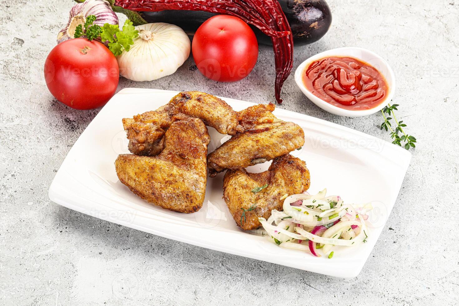 Grilled chicken wings with sauce photo