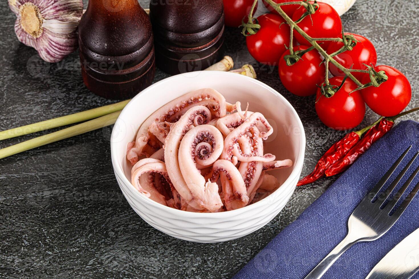 Delicous marinated squid tentacles in the bowl photo