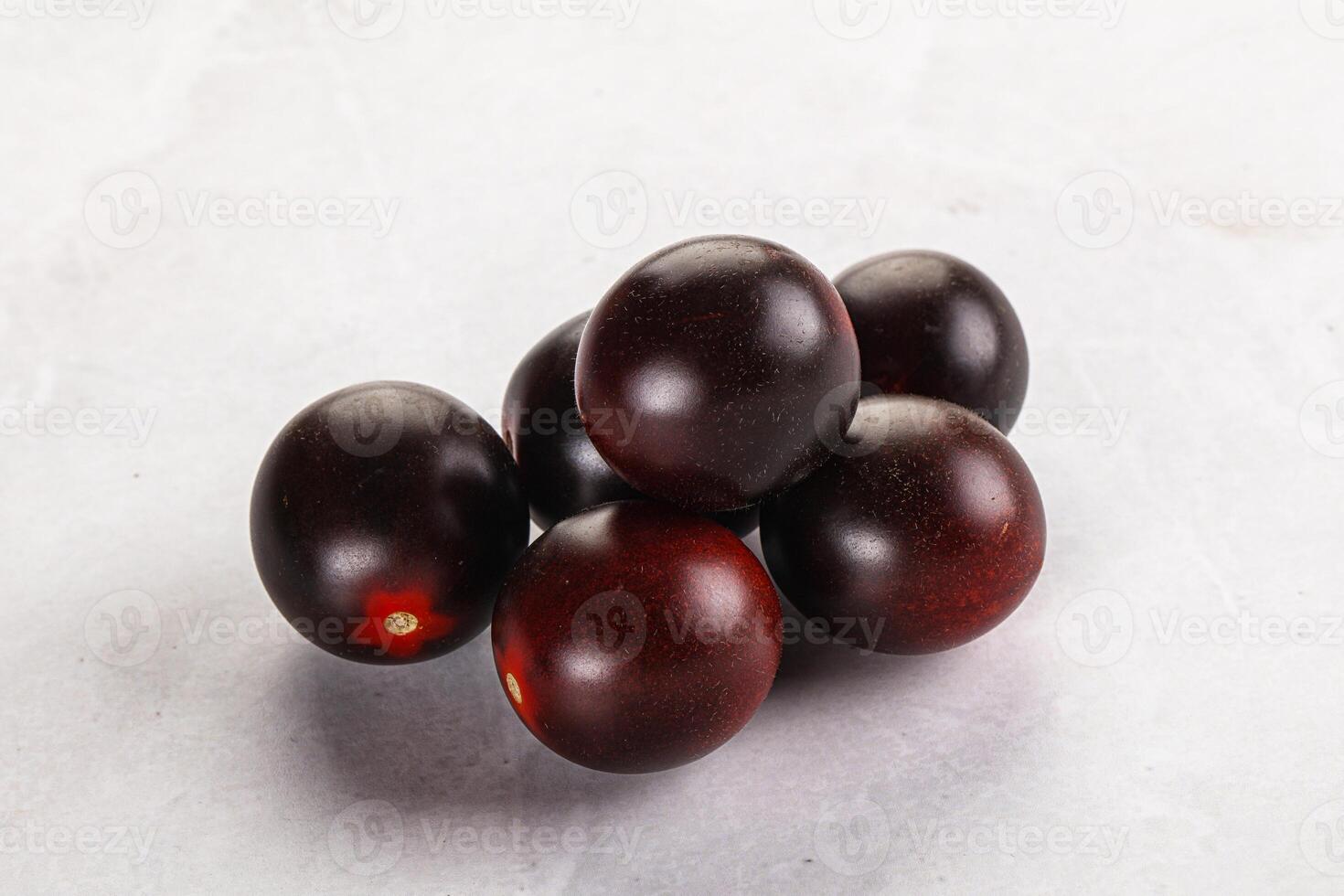 Raw ripe black kumato tomato photo