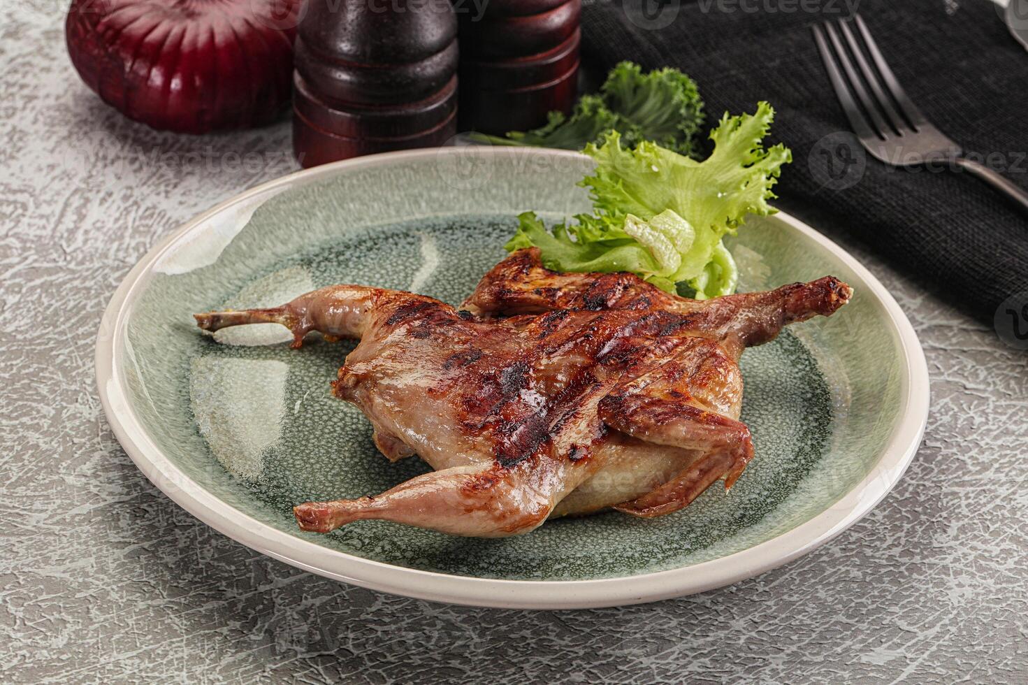 Grilled quail in the plate photo