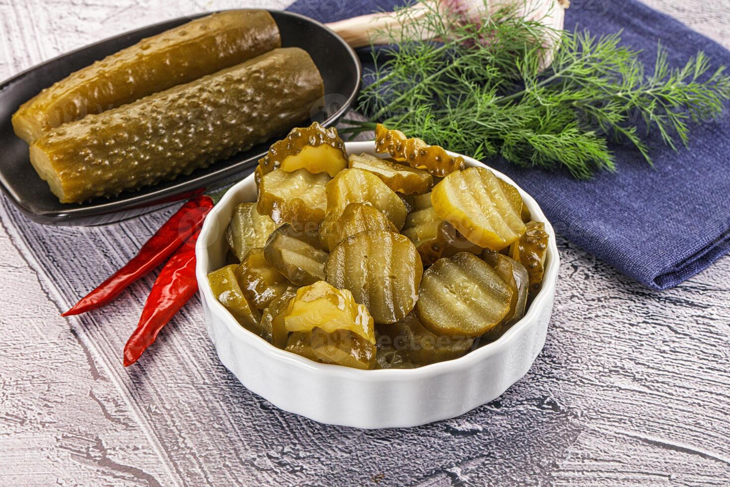 Sliced marinated cucumbers in the bowl photo