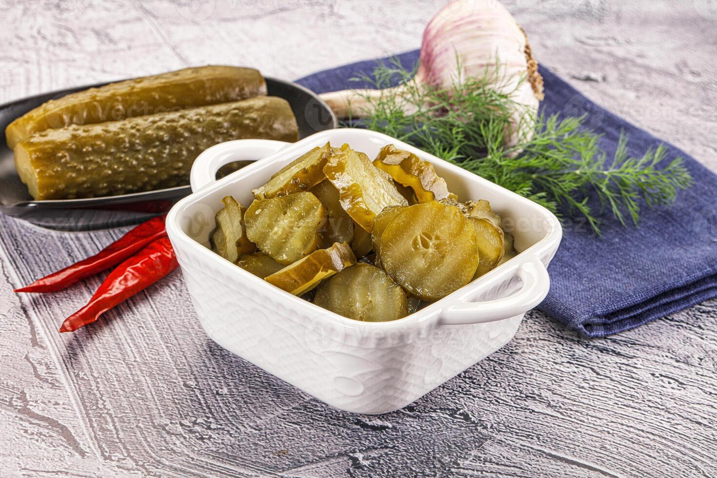 Sliced marinated cucumbers in the bowl photo