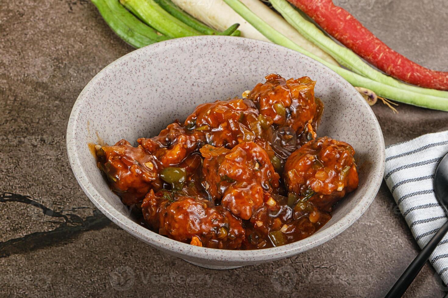 Manchurian chicken with sauce and spices photo