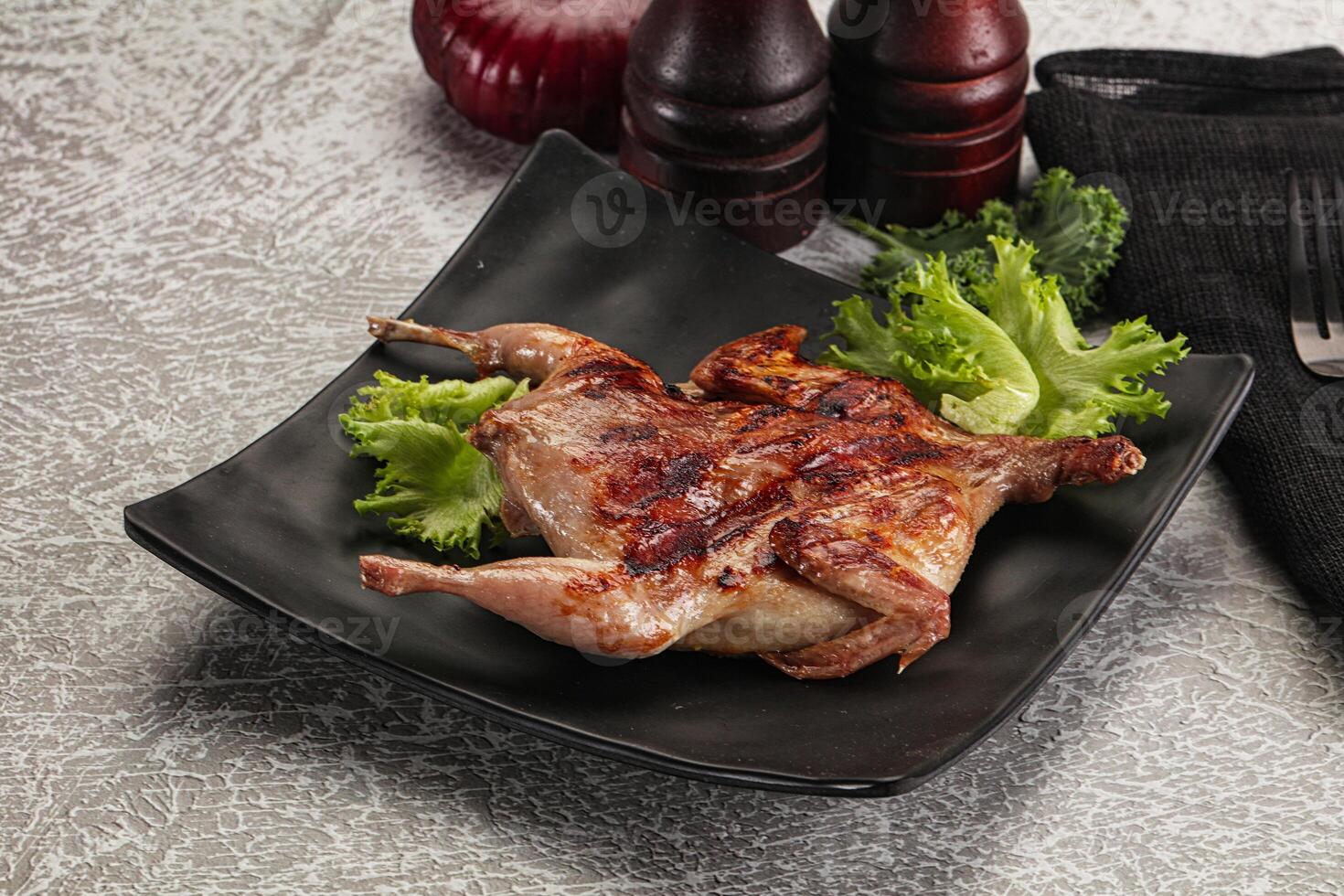 Grilled quail in the plate photo