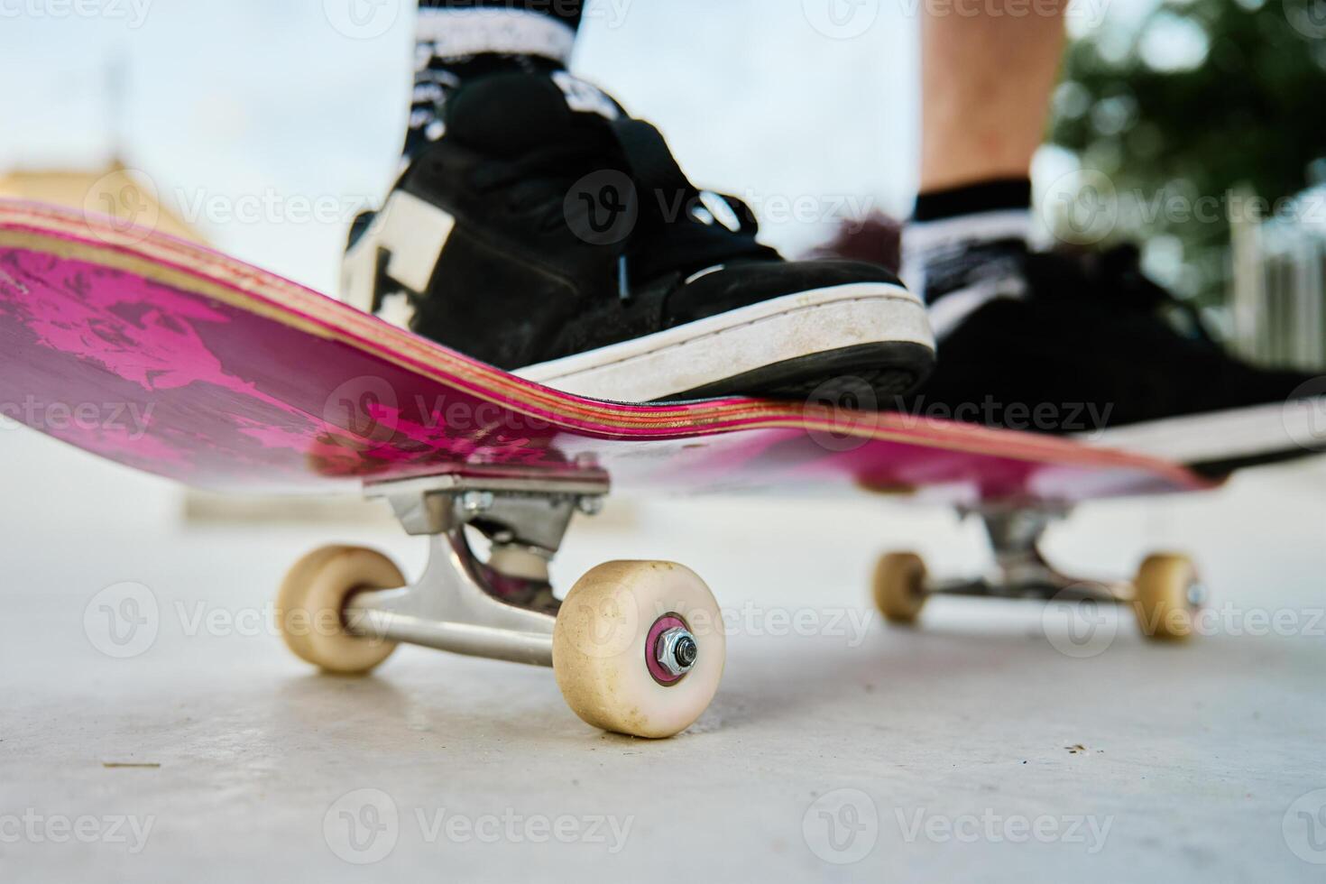 Close-Up of Skateboarder's Feet on Skateboard photo