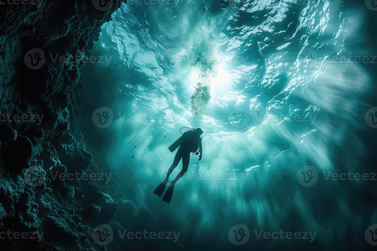 diver underwater, silhouette and sun light. photo