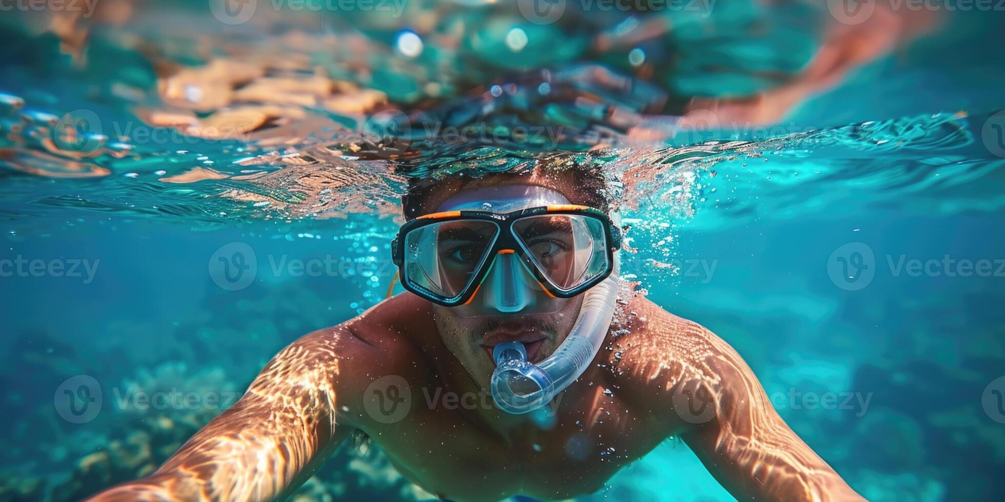 handsome man snorkeling underwater. photo