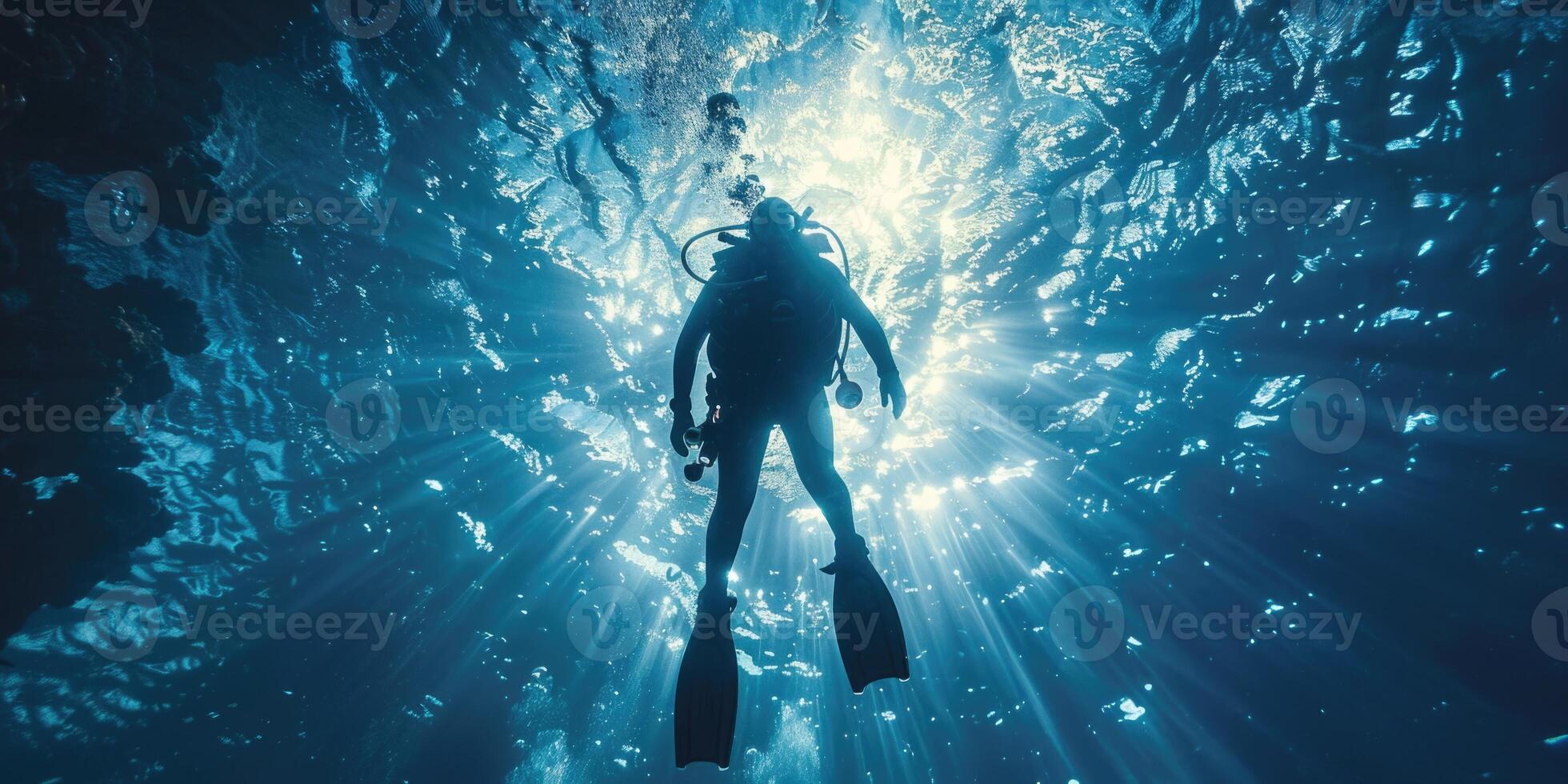 diver underwater, silhouette and sun light. photo