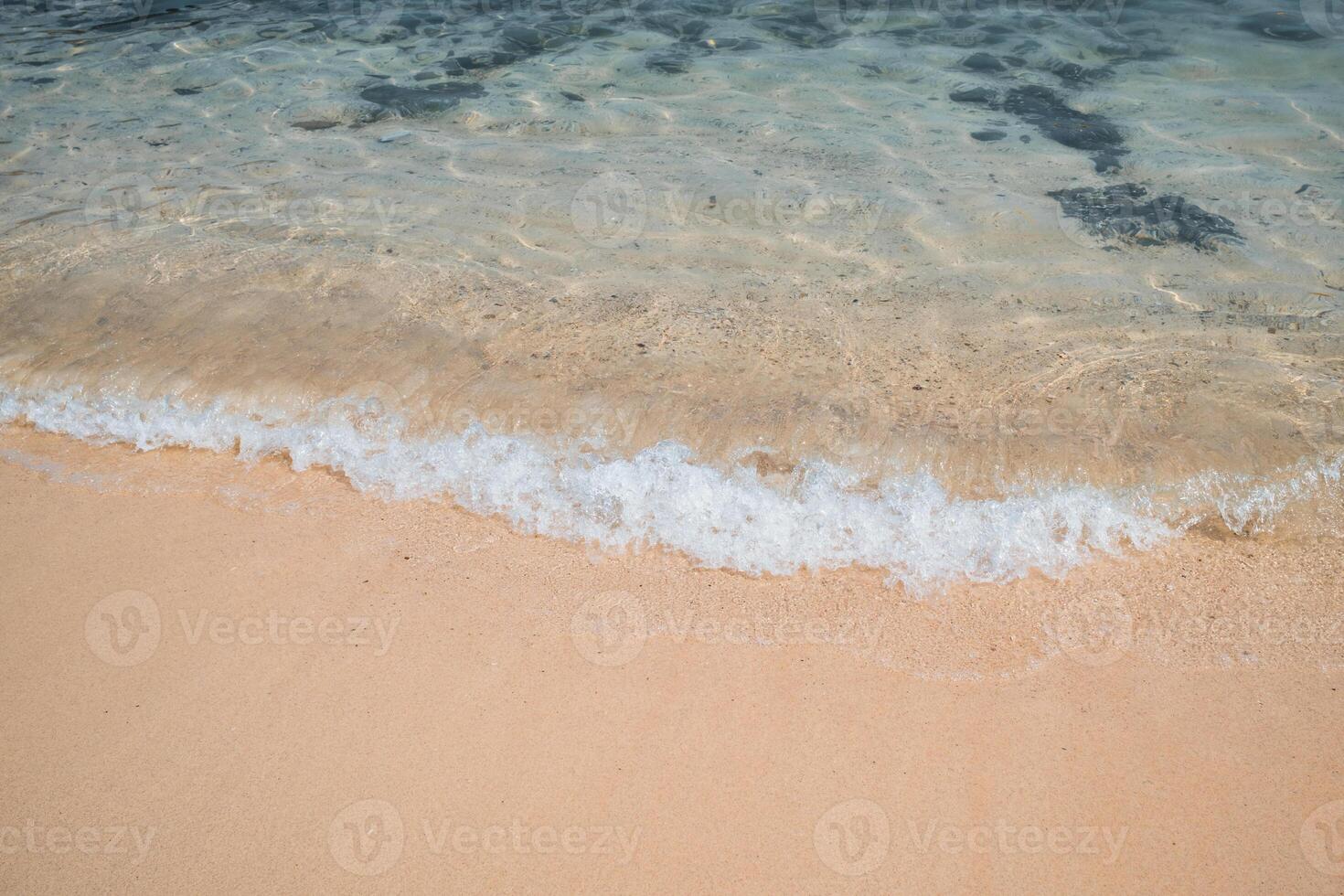 Clear wave splashing on the beach in tropical sea photo