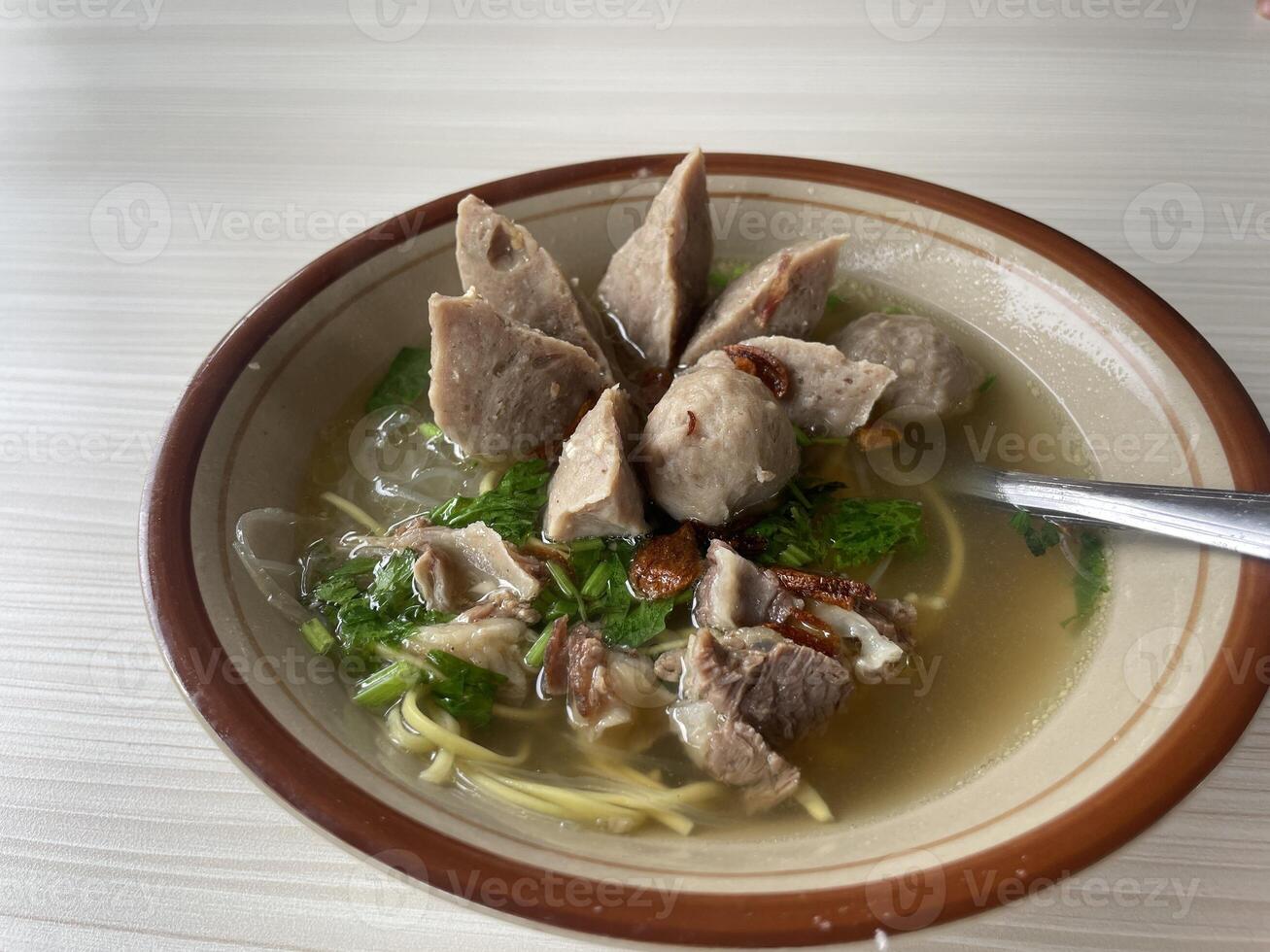 a bowl of delicious meatballs, on the table photo