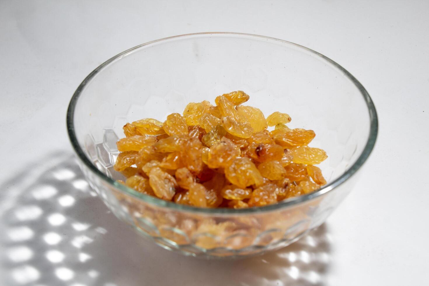 High angle view, yellow currants in a glass bowl, isolated on white photo