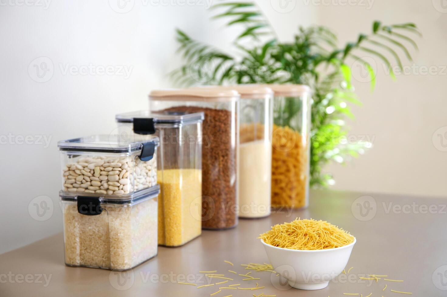 Containers for storing bulk products in the kitchen. The main focus is on pasta. photo