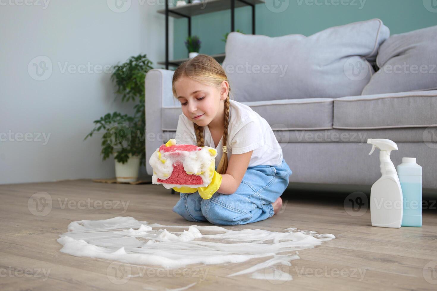 The child washes the floors of the house. The concept of child labor. The assistant. photo
