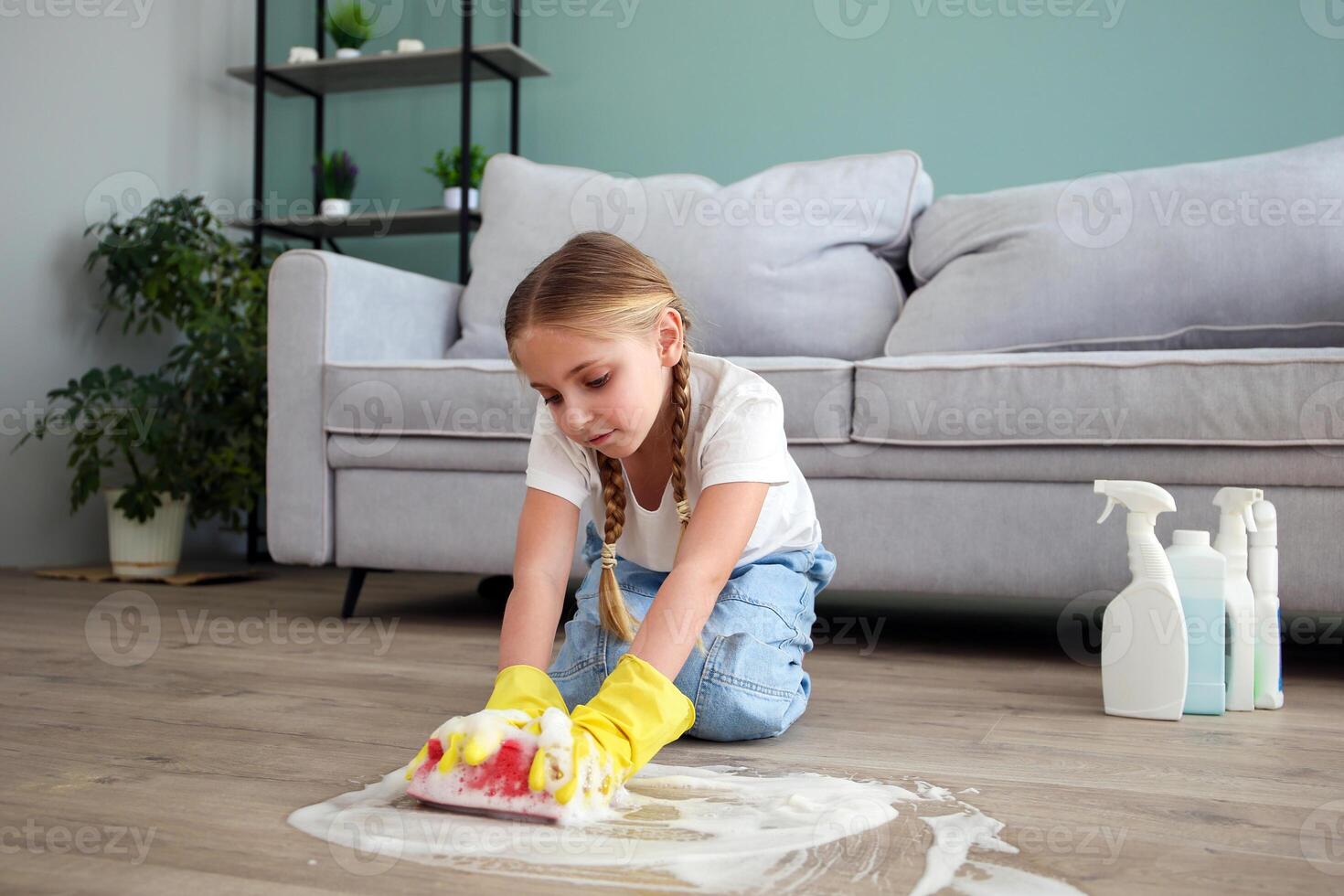 The child washes the floors of the house. The concept of child labor. The assistant. photo