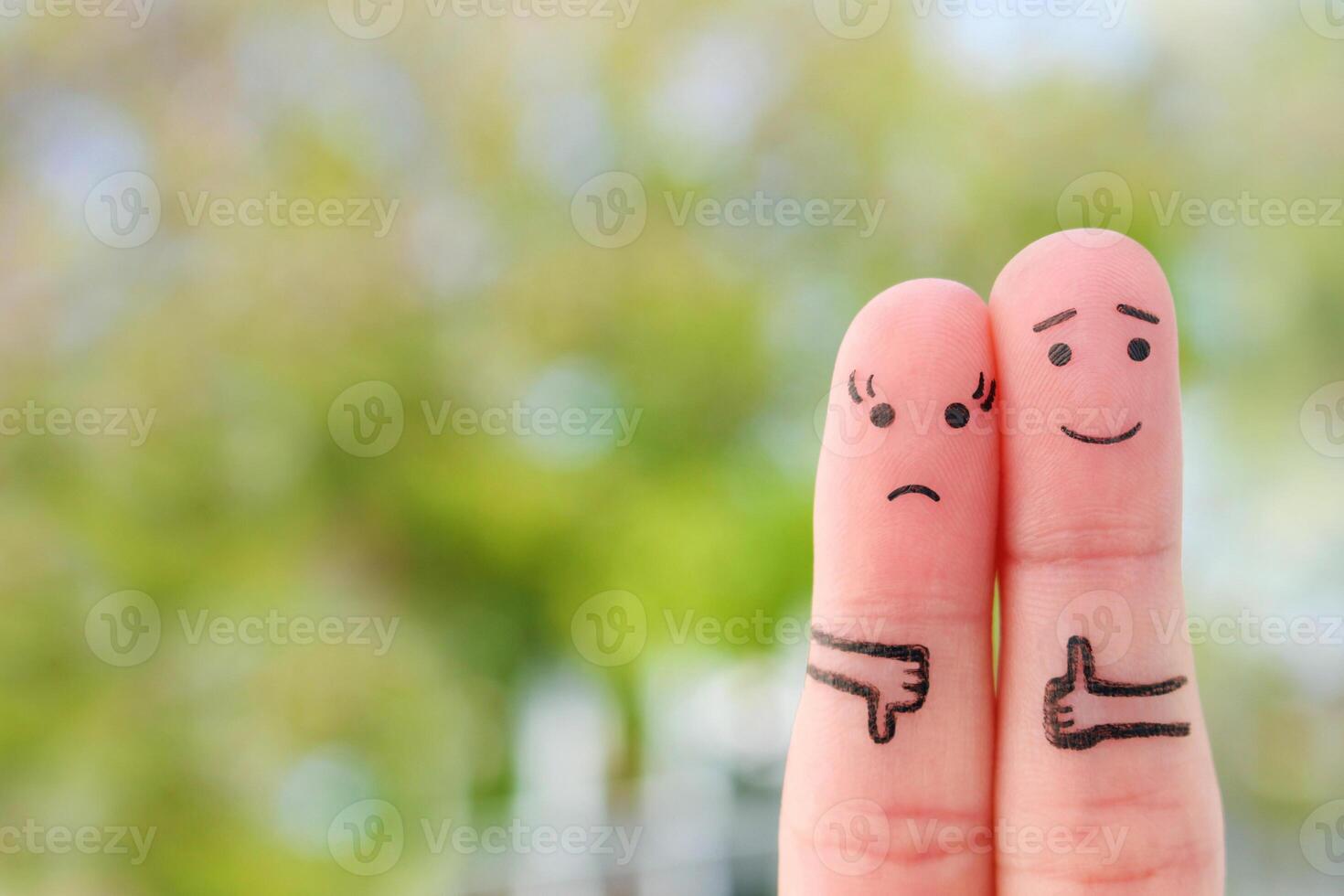 Fingers art of couple. Woman showing thumb down and man showing thumb up. Concept of disagreement in family. photo