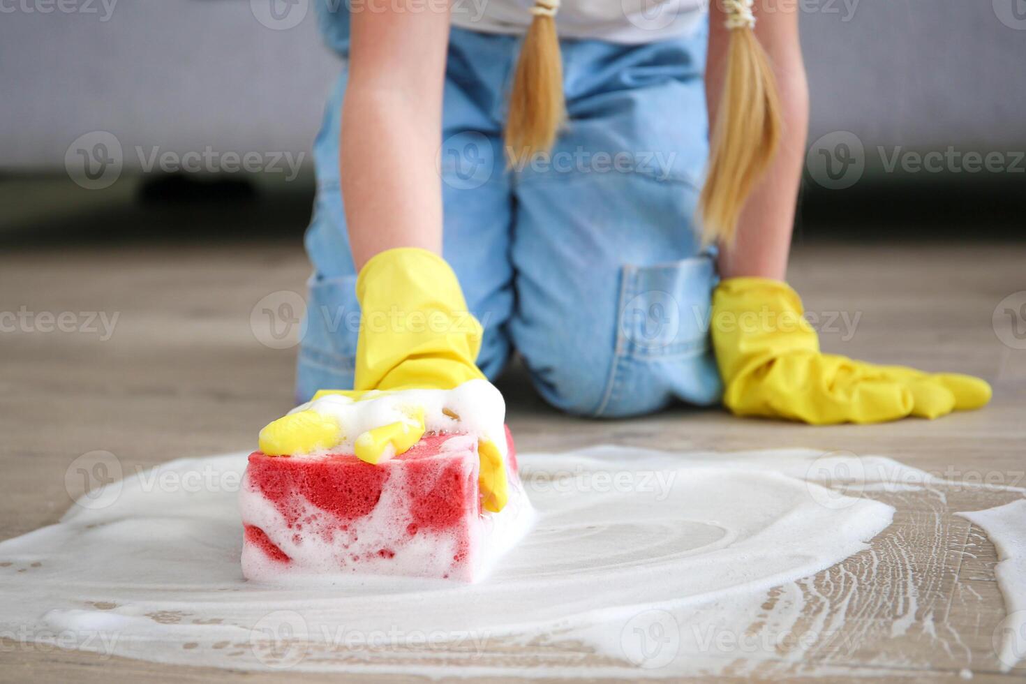 The child washes the floors of the house. The concept of child labor. The assistant. photo