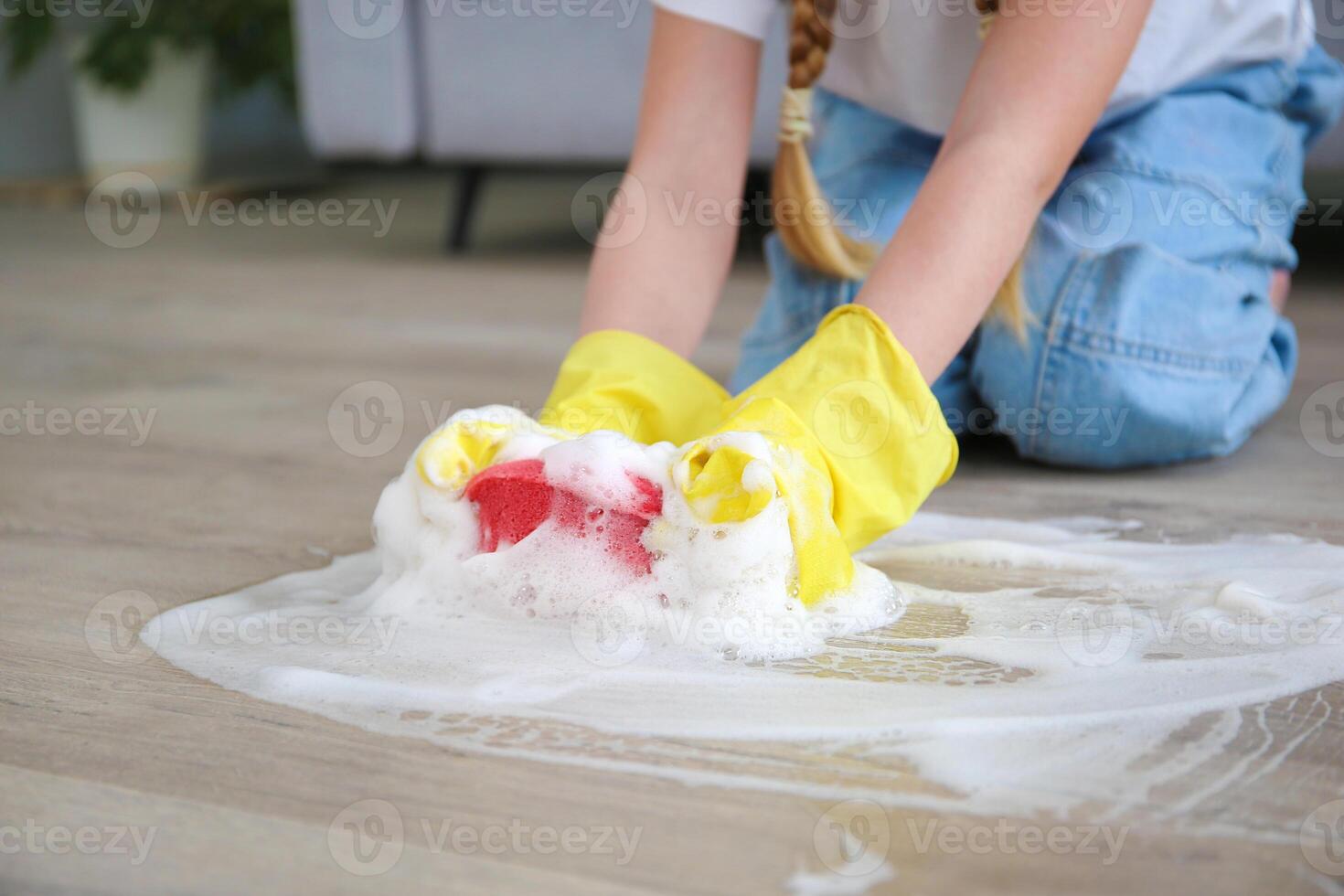 The child washes the floors of the house. The concept of child labor. The assistant. photo