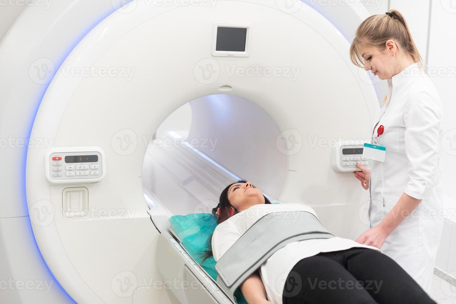 Female patient undergoing MRI - Magnetic resonance imaging in Hospital. Medical Equipment and Health Care photo