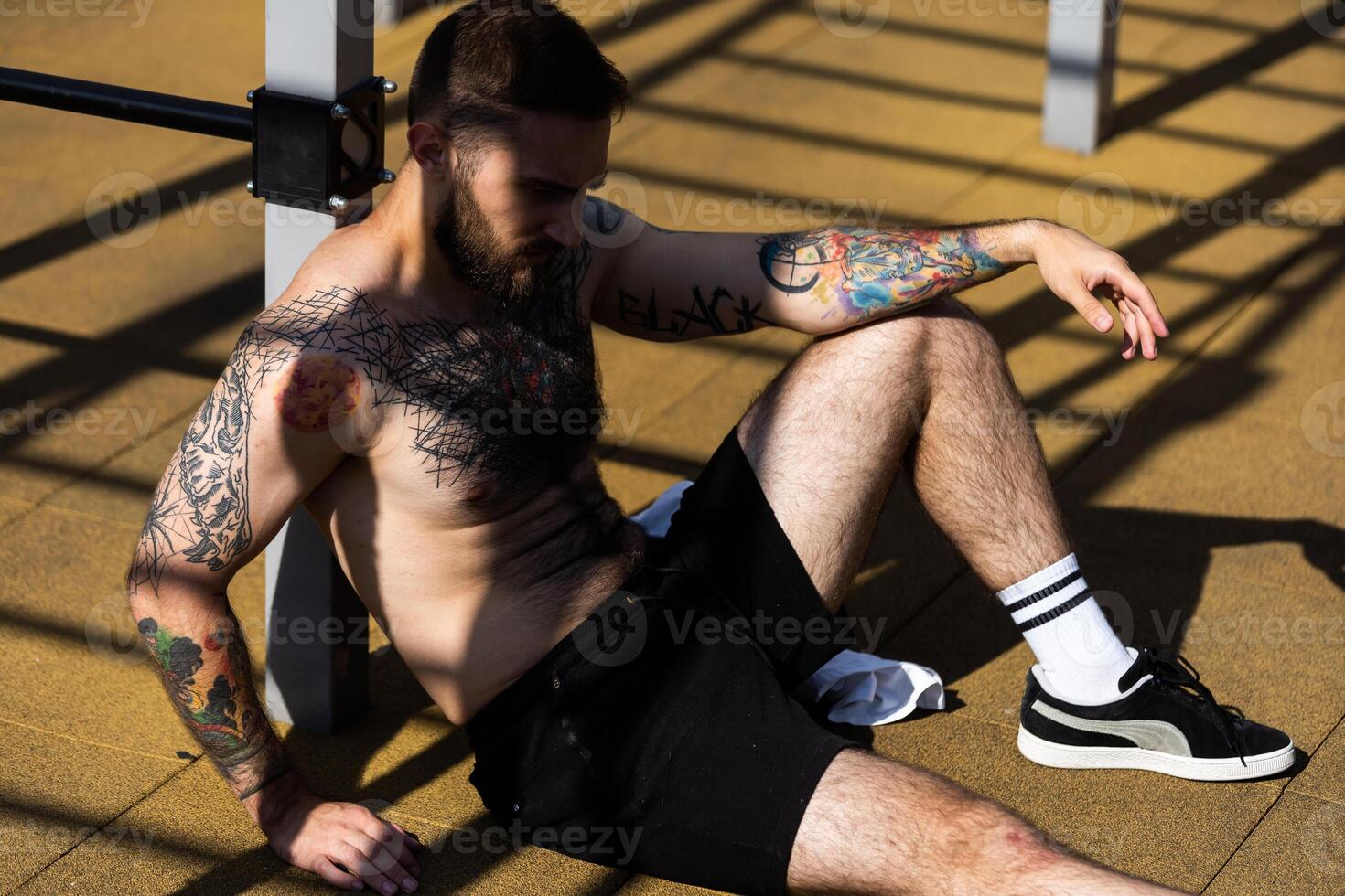a man trains on the street with exercise machines photo