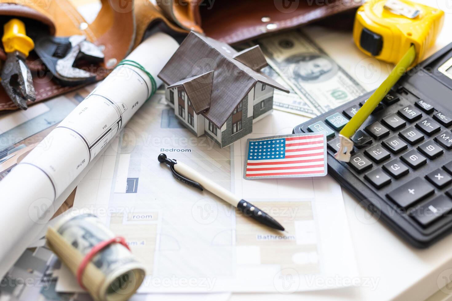 Electrical construction drawings or diagrams, work tools and accessories for engineer jobs, small house and currencies dollar, building home cost concept photo