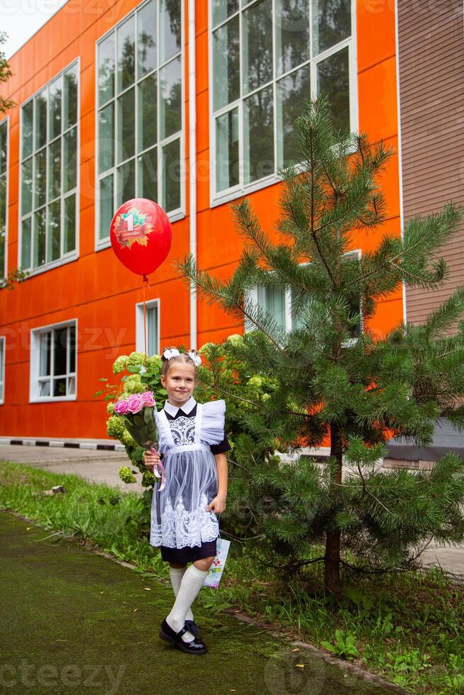 Portrait of young first grader, day of knowledge, beginning of the school year photo
