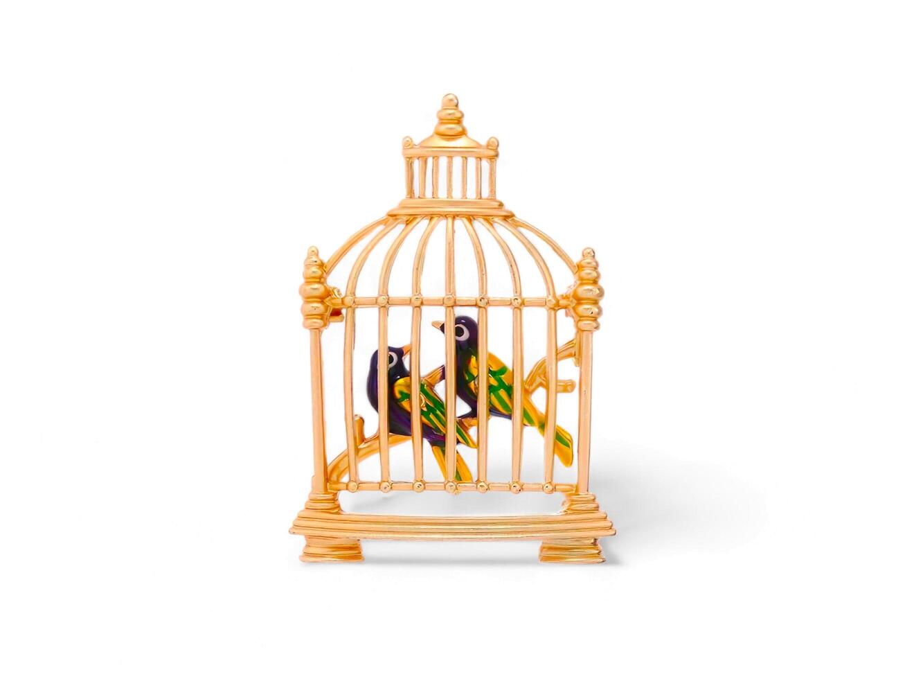 golden cage with a bird of ornament isolated on white photo