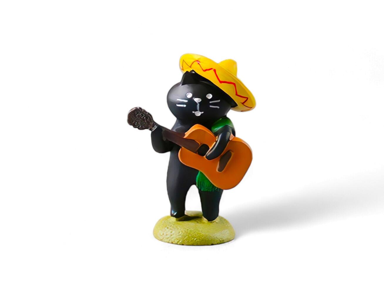 miniature toy black cat playing guitar and wearing a hat on a white background photo