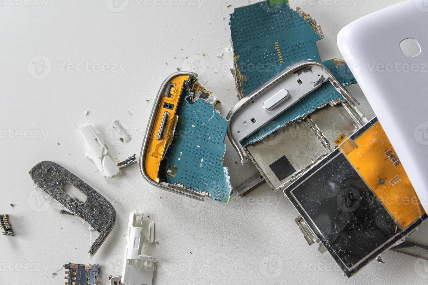 Broken white smartphone. The insides of a dropped smartphone in a white case. close-up top view photo