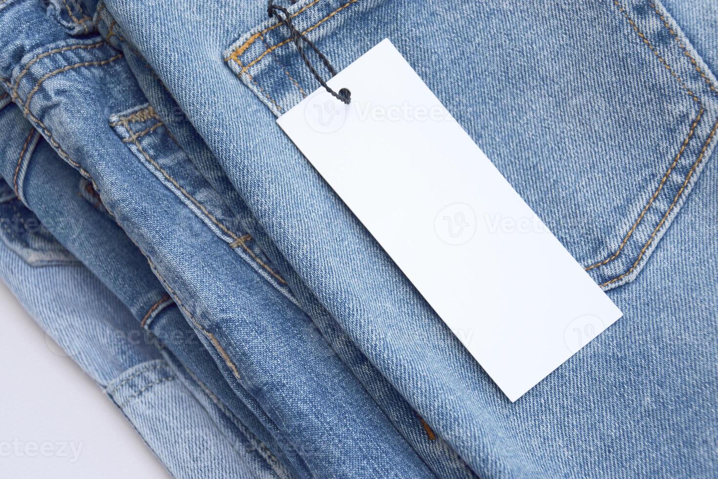 Lots of jeans pants in a stack. Denim background. photo