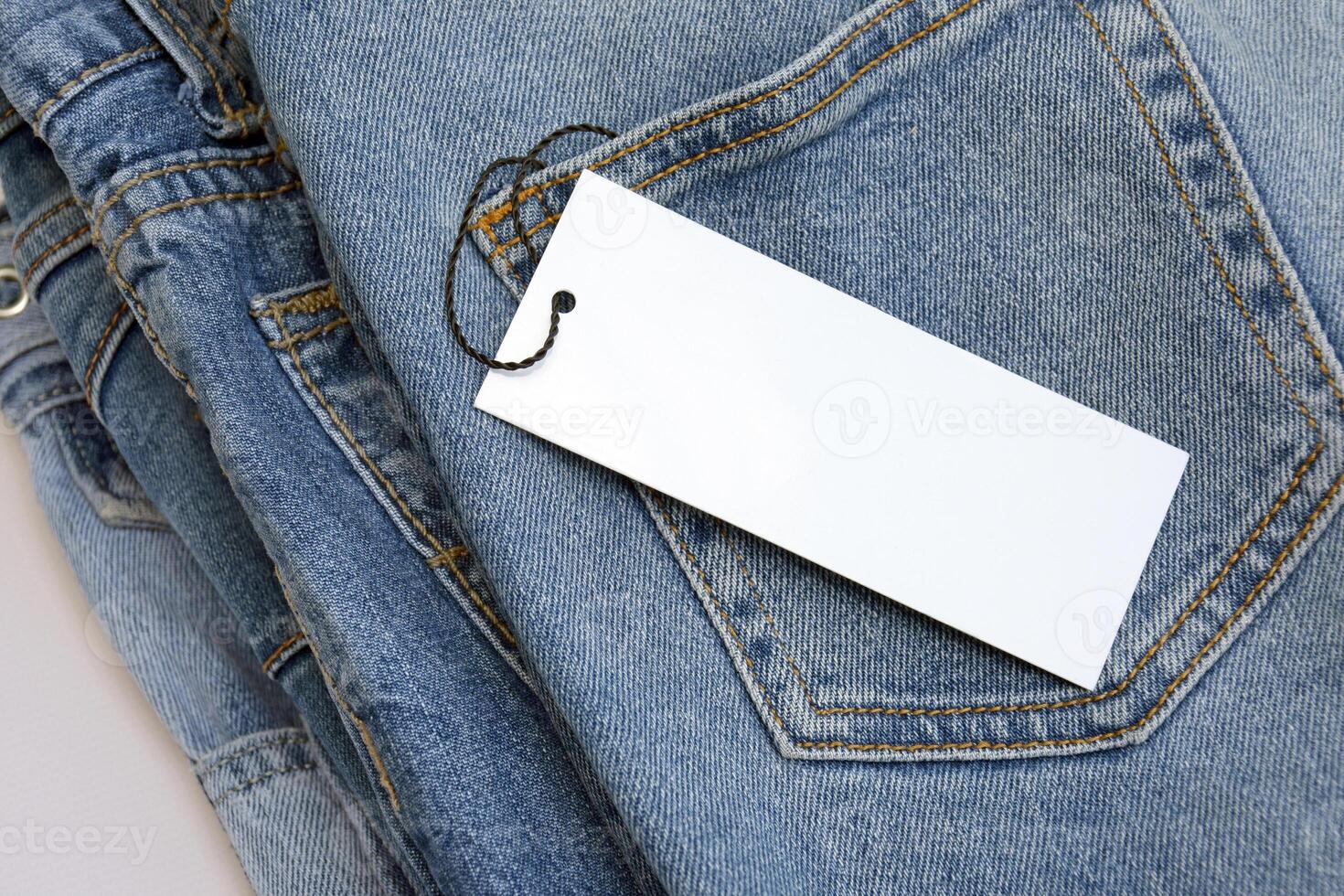 Lots of jeans pants in a stack. Denim background. photo