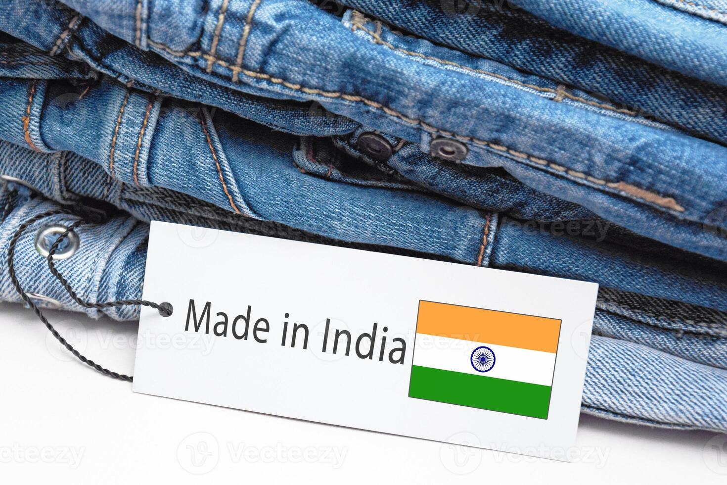 Detail of blue jeans, white label and Made in India lettering. photo