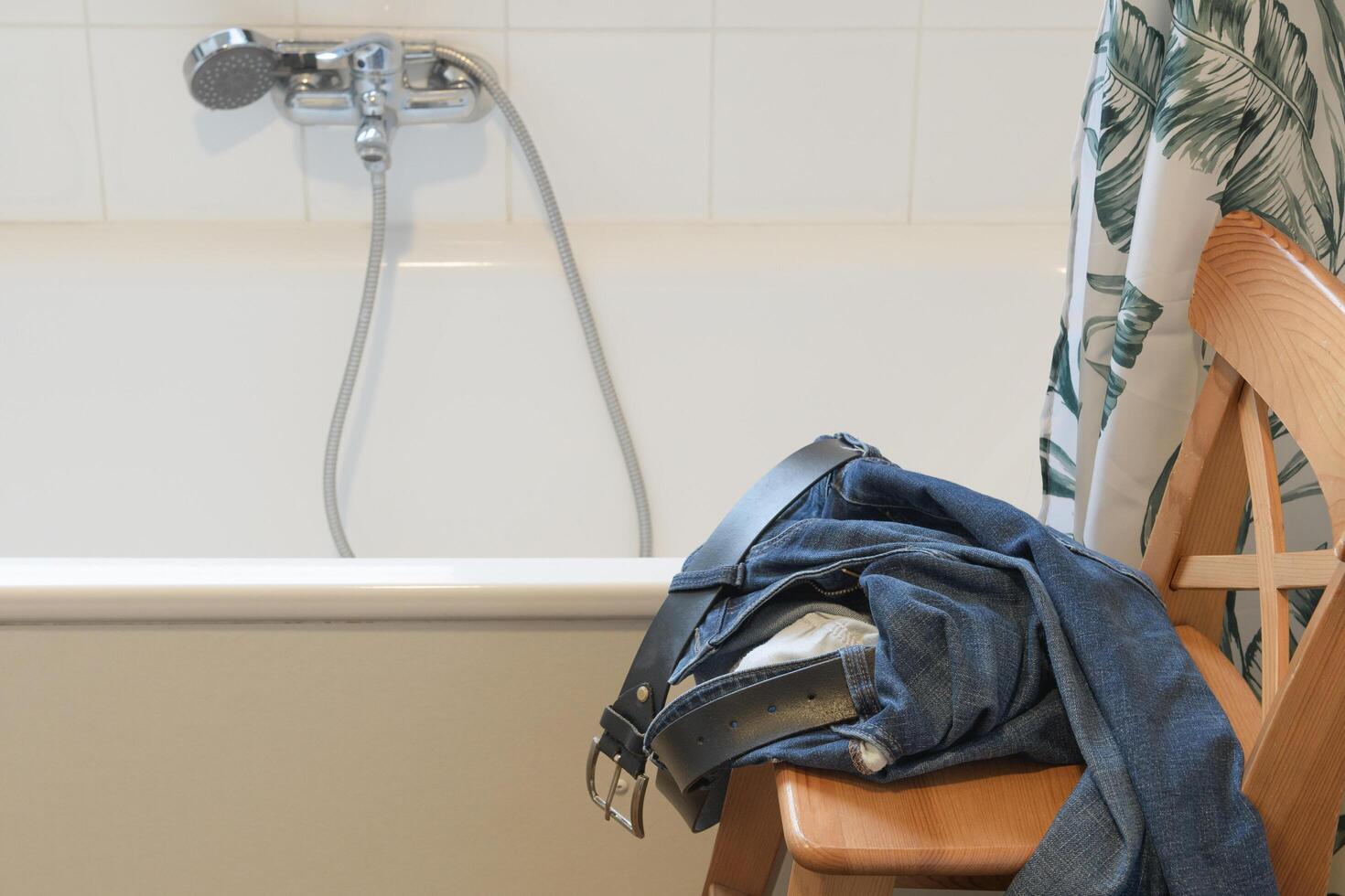 Take off jeans in the bathroom before a shower. photo