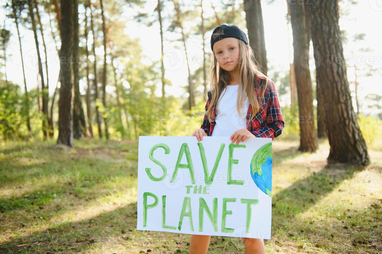 caucasian blonde girl activist with save the planet poster in park. preteen kid volunteer against pollution, global warming, recycle garbage. Ecology environmental problem. photo