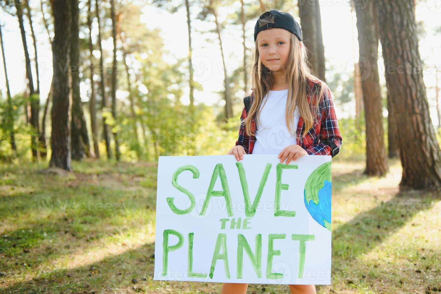 caucasian blonde girl activist with save the planet poster in park. preteen kid volunteer against pollution, global warming, recycle garbage. Ecology environmental problem. photo