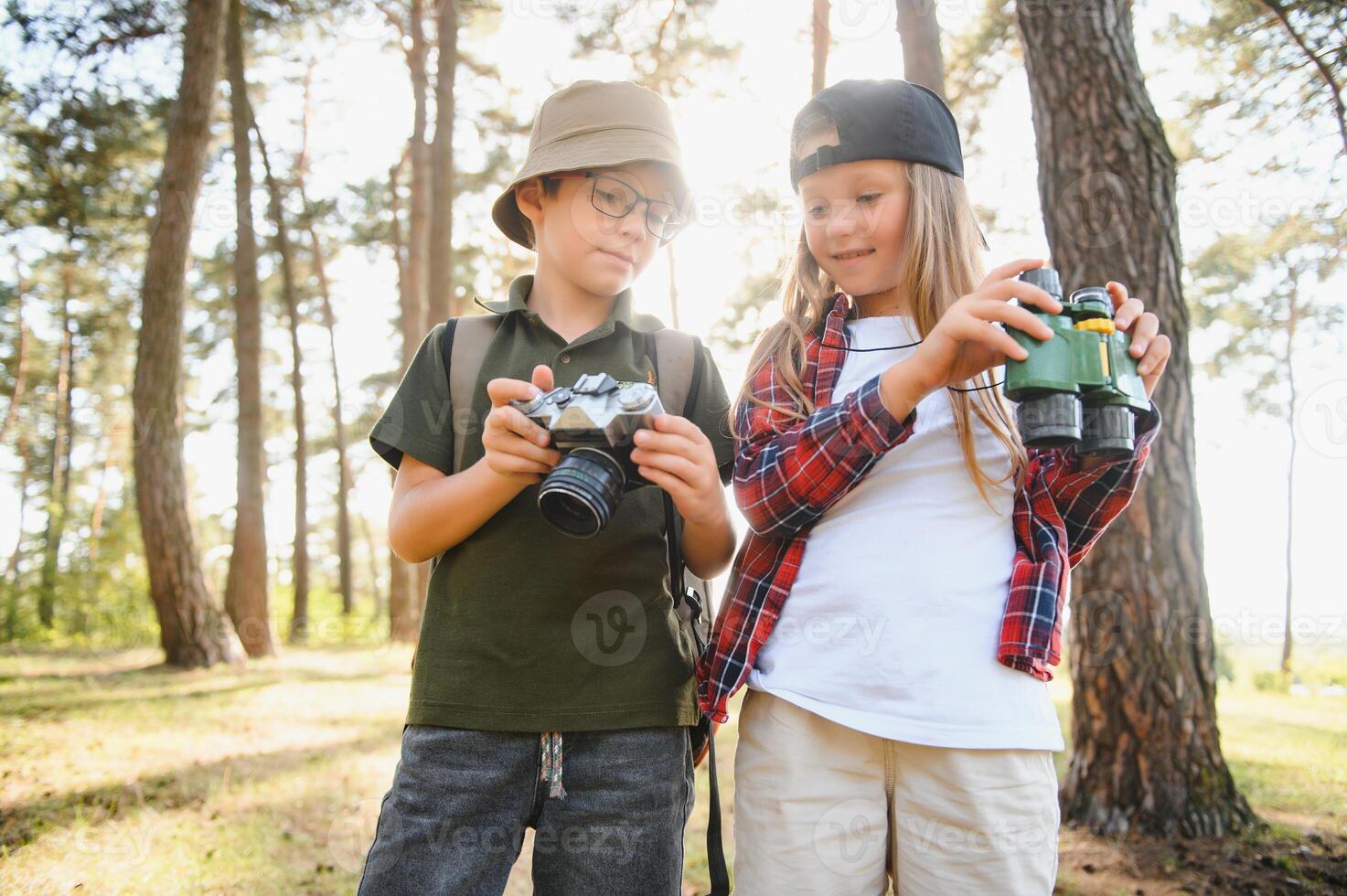 boy and girl go hiking with backpacks on forest road bright sunny day photo