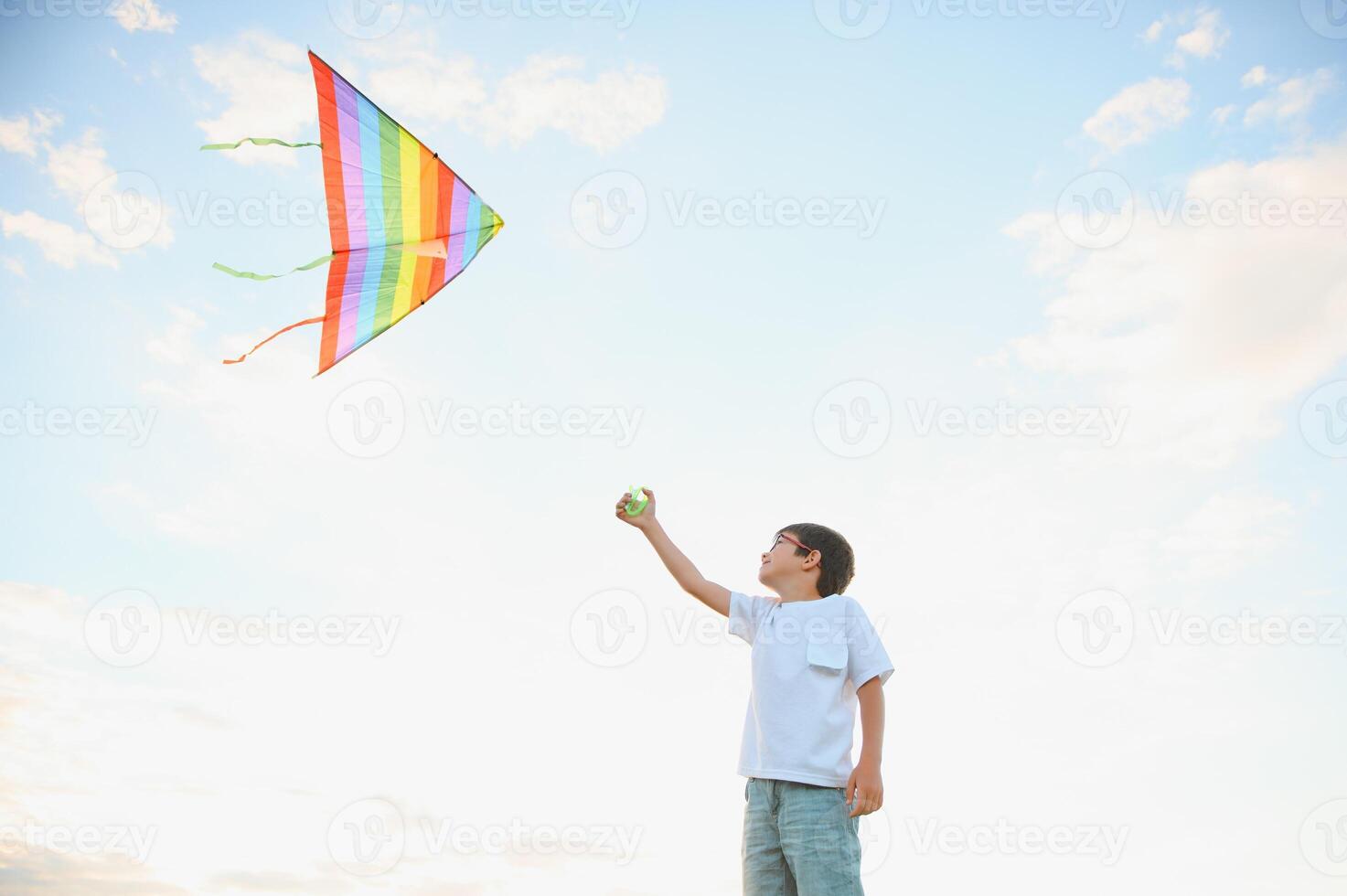 Children launch a kite in the field at sunset. photo