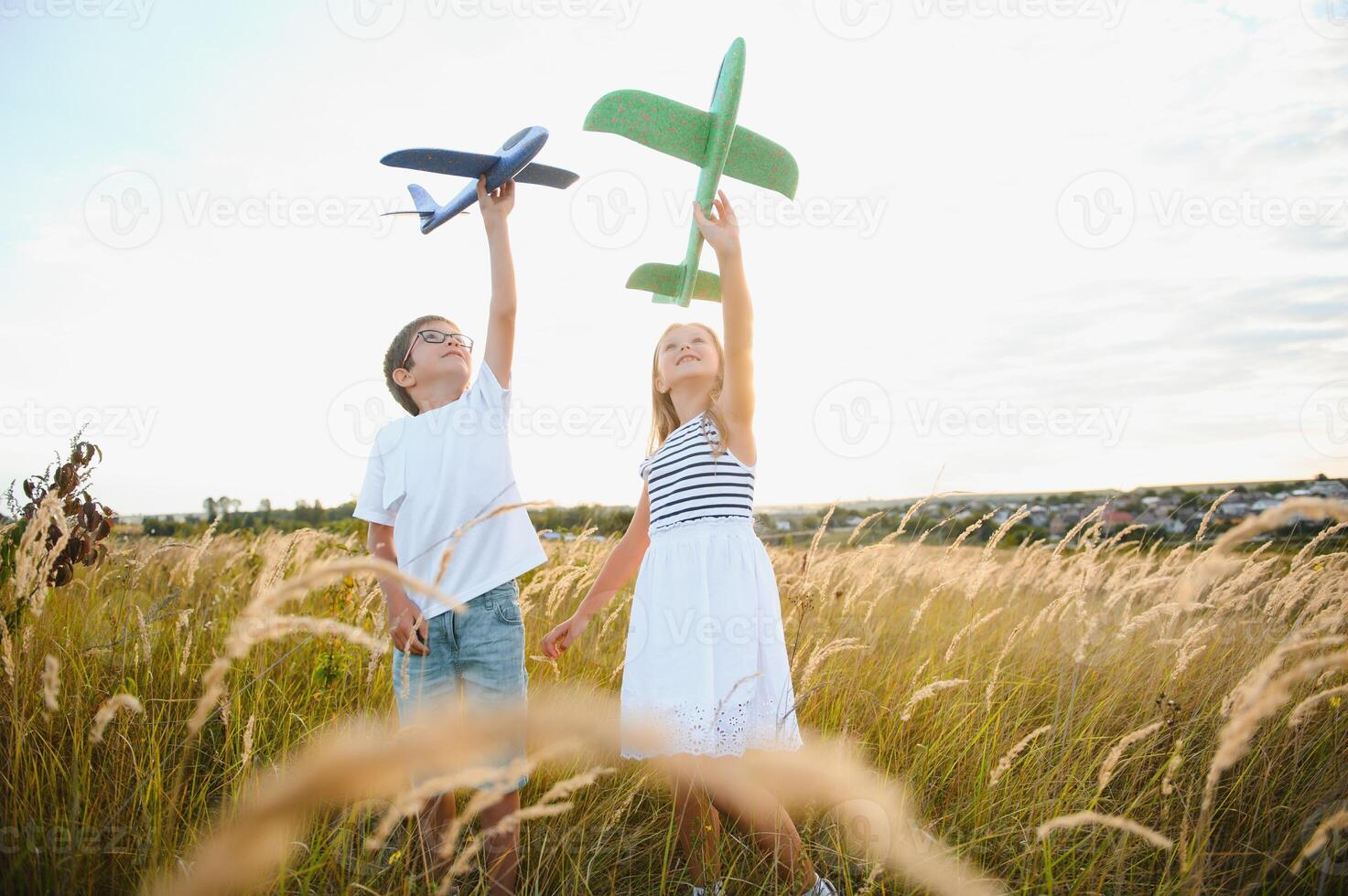 Active running kids with boy holding airplane toy. photo